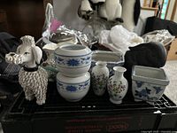 Photo of all seven ceramic planters and vases arranged on a black crate showing the variety of items.