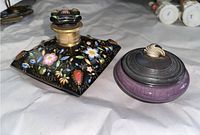 Porcelain painted flask and lidded pottery bowl together showing size relation and decoration.