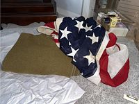 American flag wool blanket folded on carpet, showing stars and stripes design with thick wool fabric
