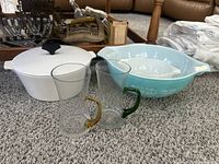 Photo showing the Pyrex covered buffet server, two hand blown glass steins with amber and green handles, and two Pyrex mixing bowls - turquoise Amish Butter Print and small white bowl.