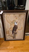 Full view of the framed acrylic painting showing the eagle perched on a branch in front of a Native American figure.