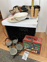 Vintage Snoopy pull toy, wood pick-up sticks, wooden salt and pepper shakers, white ceramic bowl and plate with Little Red Riding Hood design, and Superman lunchbox arranged for display.