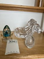 Photo showing Faberge-style egg paperweight on brass stand and clear faceted glass lion pipe rest