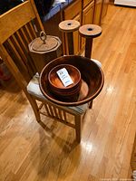Full overview of all items including wooden salad bowls nested, wooden ice bucket with lid and handle, two tall wooden spindles with metal fittings.