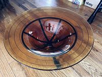 Top view of the large amber glass bowl showing circular ridges and deep basin.