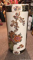 Front view of the Chinese ceramic umbrella stand showing the bird and floral hand-painted design.