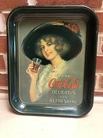 Full view of the Coca Cola tray featuring the woman in a large black hat holding a Coca Cola glass with text.