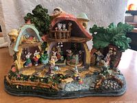 Front view of the Easter Bunny Village figurine showing overall layout with houses, bunnies, and garden details.