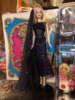 Full length view of the Barbie doll in its evening star themed gown and veil, showing overall condition and outfit details.