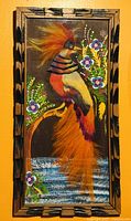 Framed Mexican feather art showing colorful bird with vibrant feathers and floral details