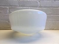 Front view of the white milk glass schoolhouse light shade showing its rounded shape and smooth surface.