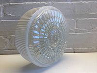 Side view showing ribbed milk white glass and clear glass top