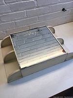 Top angled view showing curved side shelves and wear on metal edges.