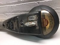 Side view of the vintage Duncan parking meter showing 'TIME EXPIRED' on the dial and coin slot with thumb turn.