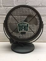 Front view of vintage Seabreeze child-proof fan showing full fan configuration with protective metal cage, dark gray base, and power cord.