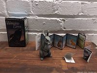 Photo of the Royal Orleans Watership Down figurine with original box and character leaflet on wooden surface in front of a white brick wall