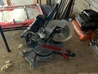 Front-angle view showing entire saw on workshop floor, base and blade condition