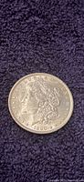 Obverse side of 1890 Morgan silver dollar showing Lady Liberty and date 1890.