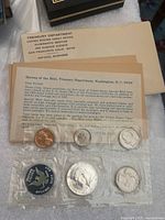 1965 US Mint Proof Coin Set in original sealed plastic packaging with official inserts from the Treasury Department and US Mint.