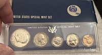 Full view of 1967 United States Special Mint Coin Set in original blue box, showing all five coins from half dollar to penny in sealed plastic packaging.