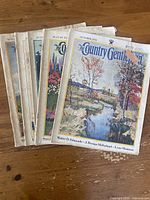 The five Country Gentleman magazines from 1933 stacked showing varied cover illustrations with rural and farm scenes.