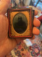 Front view of the ambrotype photograph in its case showing the soldier image and gold decorative frame.