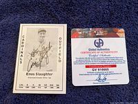 Front view of Enos Slaughter autographed baseball card alongside the Certificate of Authenticity from Global Authentics.