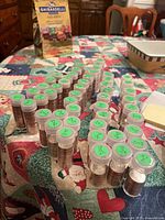 View of multiple clear plastic tubes of quarters arranged on table