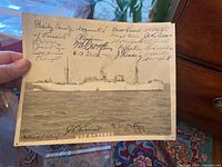 Photo of an 8x10 black and white signed photograph showing USS Antares ship with signatures from crew members.