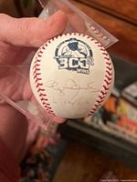 Photo of the official baseball showing the 300 wins emblem, Roger Clemens signature, and date 6 13 03