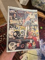 Full front cover of the Super Bowl XXV program with detailed collage of NFL symbols and team helmets.