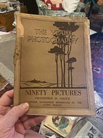 Photo of the front cover of The Year's Photography book showing artwork of trees and landscape with title and subtitle text.