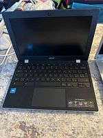 Front view of Acer Chromebook 312 with screen and keyboard visible, showing full keyboard layout and trackpad.