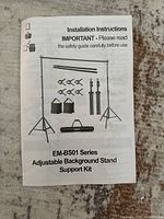Instruction manual for EM-BS01 series adjustable background stand support kit showing the components and setup.