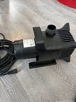 Side view of black Vivosun SP620 submersible hydroponic pump with power cord and outlet fitting.
