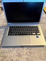 Front view of open mini laptop/chromebook showing keyboard, screen, and Intel sticker.