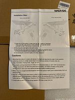 Instruction manual showing installation steps for mounting the solar street lamp on wall or pole, with cautions about sunlight and battery usage.