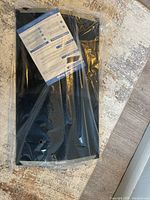 Threshold Ramp packaged in original plastic wrap on floor, showing new condition.