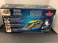 Front side of sealed Bissell Little Green Pet Stain Eraser box showing product features including lithium-ion powered, cordless convenience, spray, scrub, suction, and instant stain removal.