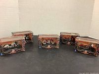 All five boxed diecast Indian Chief motorcycles displayed on black surface with white cardboard background.