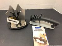 Both kitchen knife sharpeners shown side by side with instruction manual for Benewin sharpener visible.