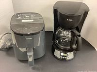 Cosori air fryer and Mr Coffee coffee maker side by side showing overall condition and size