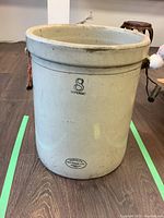 Front view of large beige Medalta stoneware pot showing capacity and brand markings.