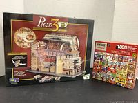 Photo showing the lot consisting of a 3D Sistine Chapel puzzle box and a Vintage Kellogg's Frosted Flakes puzzle box.
