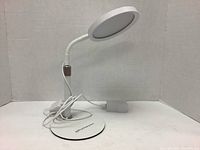 Full view of the white Shyineyou branded red light therapy table lamp, adjustable neck, and circular LED light panel.