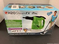 Front view of the boxed H2O Steam FX Pro showing the product image and branding, highlighting the 5-in-1 functions and sanitizing claims.