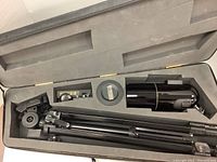 Open hard case showing telescope, tripod and accessories fitted inside