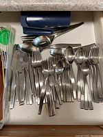 Drawer with stainless steel cutlery: forks, knives, spoons