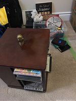 Full view of games and spinning CD holder on carpet