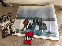 Photo showing the full poster of The Tragically Hip, two magazines including Refined with The Hip on cover, and a pair of red socks.